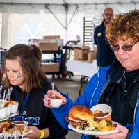 Alumni enjoy delicious food at the tailgate